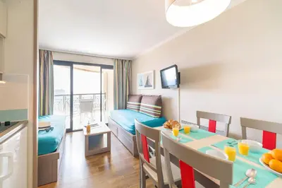a living room with a room with a dining room at Résidence La Palme d'Azur Cannes Verrerie in Cannes