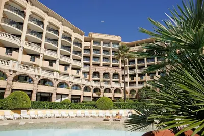 a large building with a pool in front of it at Résidence La Palme d'Azur Cannes Verrerie in Cannes