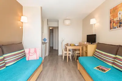a small room with two beds and a table at Résidence La Palme d'Azur Cannes Verrerie in Cannes
