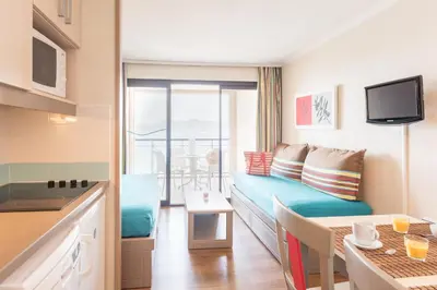 a small apartment with a couch and a table and a kitchen at Résidence La Palme d'Azur Cannes Verrerie in Cannes