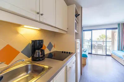 a kitchen with a sink and a counter at Résidence La Palme d'Azur Cannes Verrerie in Cannes