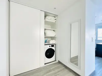 a laundry room with a washer and dryer at Le Royal Carnot - Studio - Cannes Centre Terrasse in Cannes