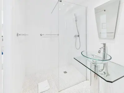 a bathroom with a glass shower and a sink at Central -300m Palais- Seaview-A/C-WIFI-spacieux in Cannes