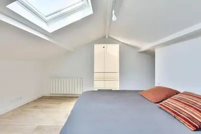a bedroom with a large bed and a skylight at Villa vue mer Cannes in Mougins