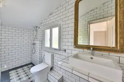 a bathroom with a sink and a toilet and a mirror at Villa vue mer Cannes in Mougins