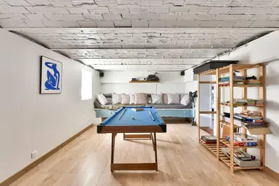 a room with a ping pong table and a couch at Villa vue mer Cannes in Mougins