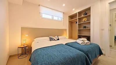 a bedroom with a large bed with a blue blanket at Viva Riviera Brand New Top Floor close Croisette in Cannes
