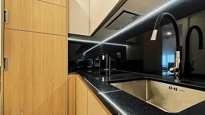 a kitchen with a sink and black counter tops at Viva Riviera Brand New Top Floor close Croisette in Cannes