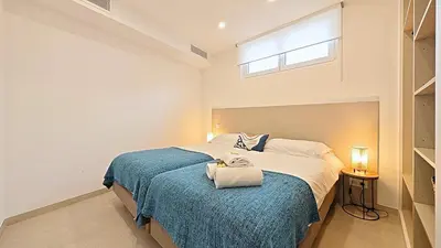 a bedroom with a large bed with a blue blanket at Viva Riviera Brand New Top Floor close Croisette in Cannes