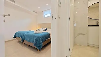 a bedroom with a bed with a blue blanket at Viva Riviera Brand New Top Floor close Croisette in Cannes