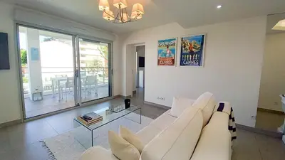 a living room with a white couch and a table at Bella Park in Cannes
