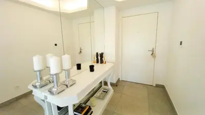 a bathroom with a white counter with a mirror at Bella Park in Cannes