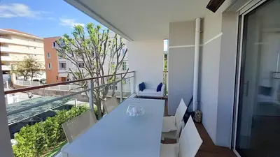 a white table and chairs on a balcony with a view at Bella Park in Cannes