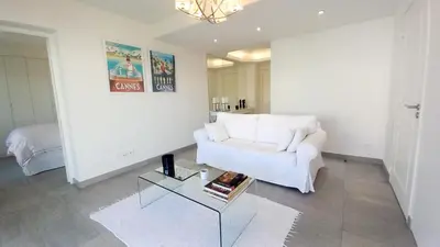 a living room with a white couch and a table at Bella Park in Cannes