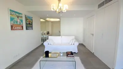 a living room with a white couch and a table at Bella Park in Cannes
