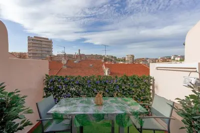 a cat sitting on a table on a balcony at Un Écrin au Suquet - Studio, clim, balcon, plage, Palais des Festivals in Cannes