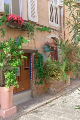 a building with potted plants on the side of it at Un Écrin au Suquet - Studio, clim, balcon, plage, Palais des Festivals in Cannes