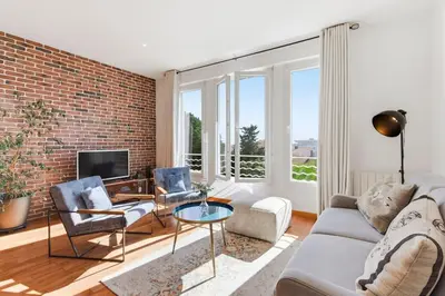 a living room with a brick wall at Cozy 1 bedroom flat,free parking, close to center in Cannes