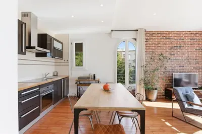 a kitchen with a table and a dining room at Cozy 1 bedroom flat,free parking, close to center in Cannes