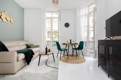 a living room with a couch and a table at The Green Sun YourHostHelper in Cannes