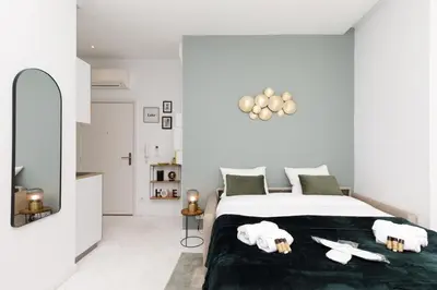 a bedroom with a bed with towels on it at The Green Sun YourHostHelper in Cannes