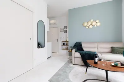 a living room with a couch and a table at The Green Sun YourHostHelper in Cannes