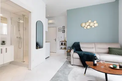 a living room with a couch and a table at The Green Sun YourHostHelper in Cannes