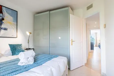 a bedroom with a large bed with towels on it at 3-Room Luxury Apartment with Pool and Sea View Steps from the Beach in Cannes