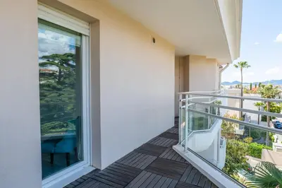 a balcony with a view of the ocean at 3-Room Luxury Apartment with Pool and Sea View Steps from the Beach in Cannes