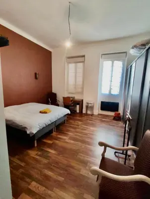 a bedroom with a bed and a wooden floor at CANNES t4 bourgeois 790M de la plage, Palais et Croisette in Cannes