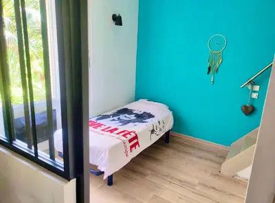 a room with a small bed in a room with blue walls at CANNES t4 bourgeois 790M de la plage, Palais et Croisette in Cannes