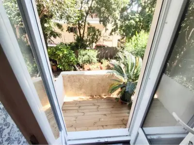an open door to a patio with a potted plant at CANNES t4 bourgeois 790M de la plage, Palais et Croisette in Cannes