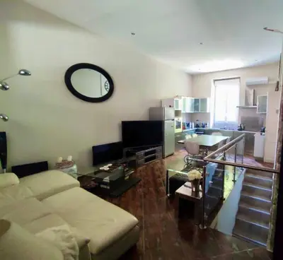 a living room with a couch and a mirror on the wall at CANNES t4 bourgeois 790M de la plage, Palais et Croisette in Cannes