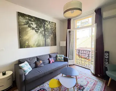 a living room with a couch and a window at cannes meynadier in Cannes