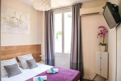 a bedroom with a bed and a window at cannes meynadier in Cannes