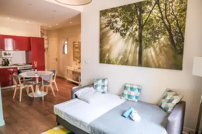 a living room with a couch and a kitchen at cannes meynadier in Cannes