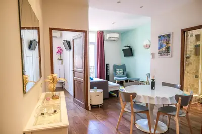 a small living room with a table and chairs at cannes meynadier in Cannes