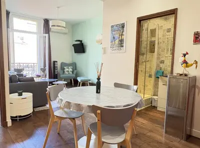 a kitchen and living room with a table and chairs at cannes meynadier in Cannes