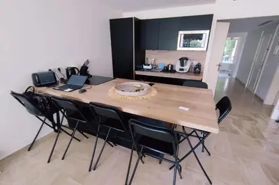 a dining room table with black chairs in a kitchen at WE CANNES ! Exceptional 4 rooms apartment Cannes Center swimming pool in Cannes