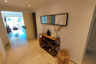 a living room with a large mirror on the wall at WE CANNES ! Exceptional 4 rooms apartment Cannes Center swimming pool in Cannes