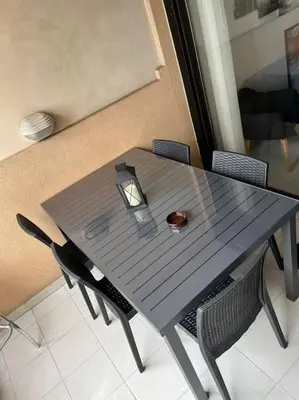 a table with chairs and a candle on top of it at Appartement vue sur mer in Cannes