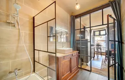 a bathroom with a shower with a sink and a mirror at Red & Bleue YourHostHelper in Cannes