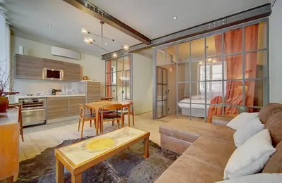 a living room with a couch and a table at Red & Bleue YourHostHelper in Cannes