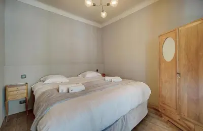 a bedroom with two beds with towels on them at Red & Bleue YourHostHelper in Cannes