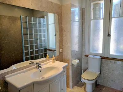 a bathroom with a sink and a toilet and a mirror at Citilet Louis Blanc 1,2,3 - Three gorgeous, open-plan apartments in Cannes