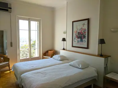 a hotel room with two beds and a window at Citilet Louis Blanc 1,2,3 - Three gorgeous, open-plan apartments in Cannes