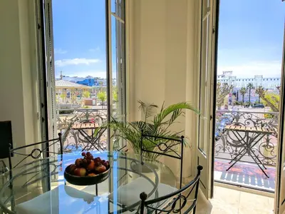 a glass table with a bowl of fruit on a balcony at Citilet Louis Blanc 1,2,3 - Three gorgeous, open-plan apartments in Cannes