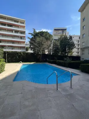 a large blue swimming pool in a building at Ambre d' Or apartment by Welcome to Cannes in Cannes