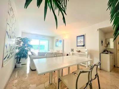 a living room with a white table and chairs at Ambre d' Or apartment by Welcome to Cannes in Cannes