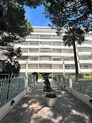 a large white building with trees in front of it at Ambre d' Or apartment by Welcome to Cannes in Cannes